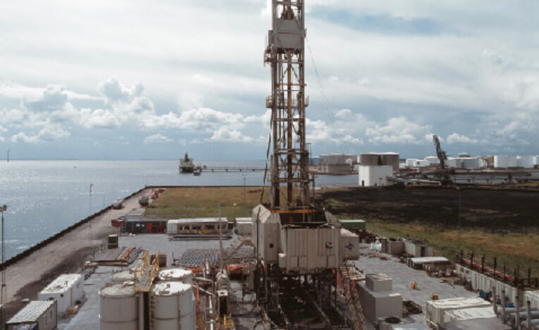 A drilling rig by the coast.