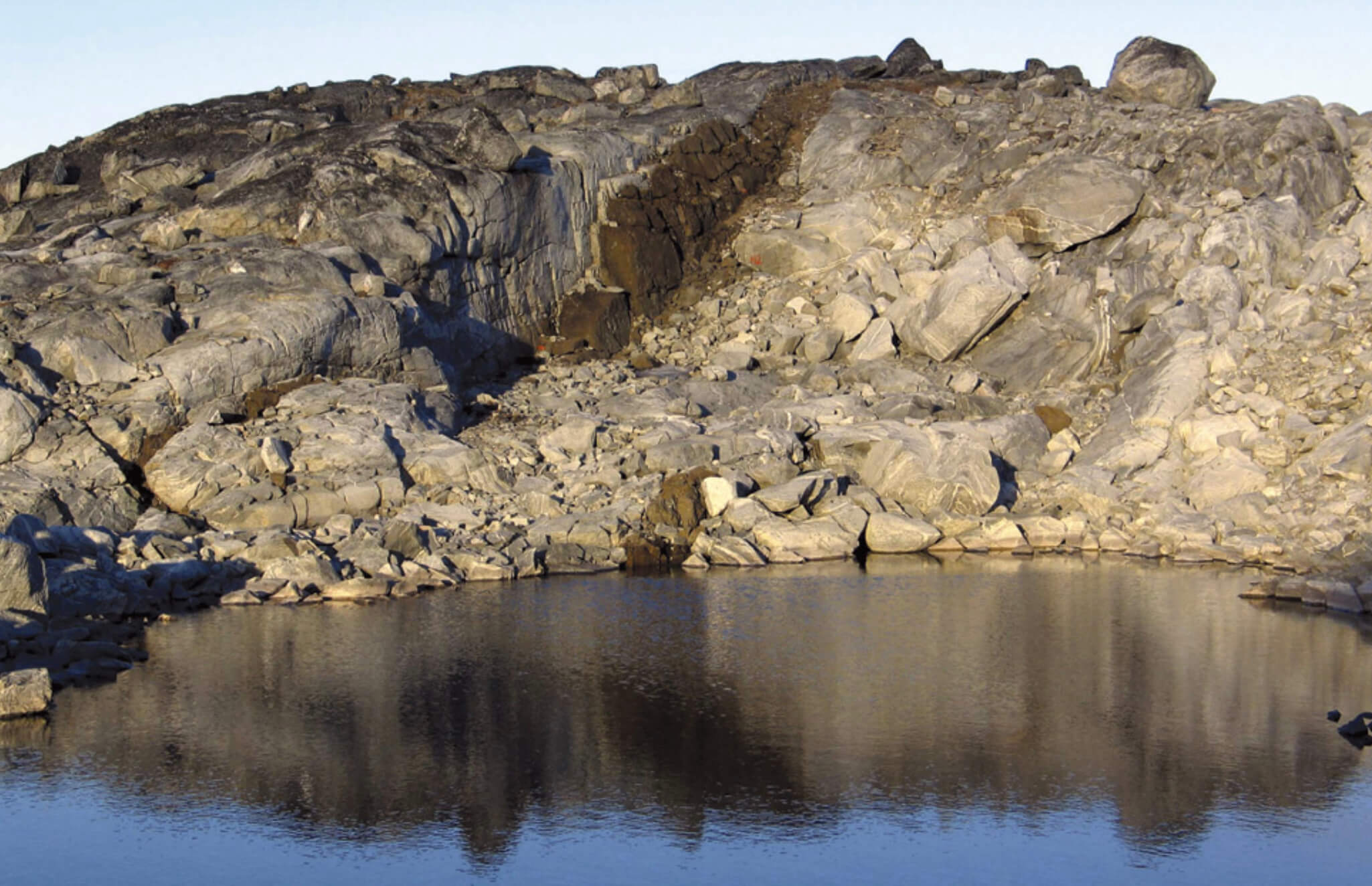 Rock exposure with water in the foreground.