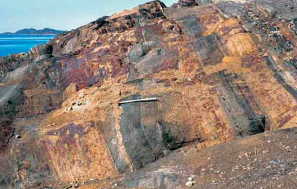 View of geological formations with a hammer for scale.