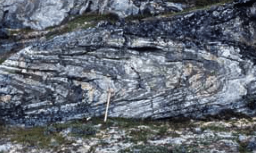 Rock formations with a hammer for scale.