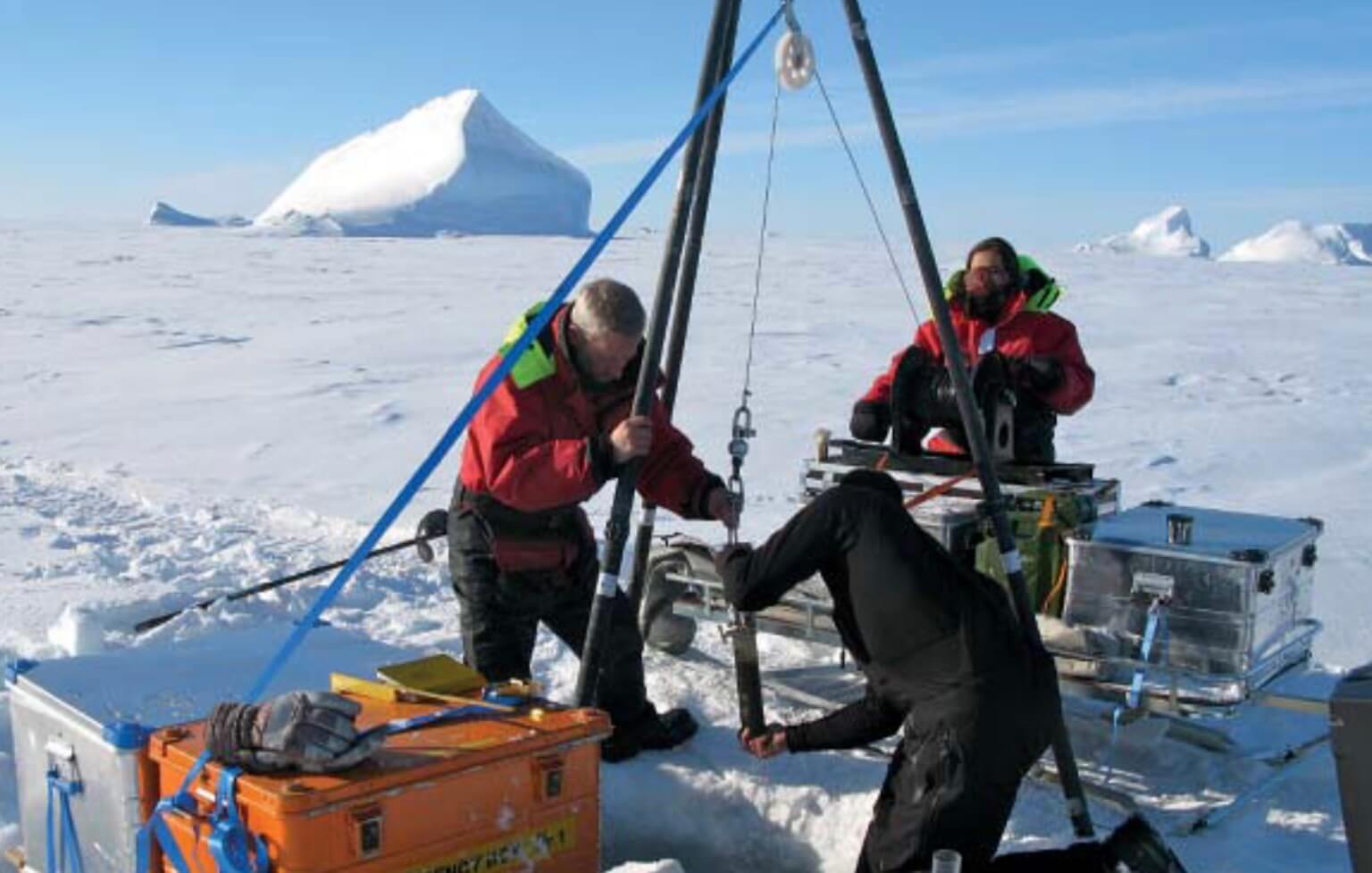 Three people working on the ice.